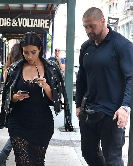 June 17, 2014 - New York City, NY, United States - June 17 2014, New York City....TV personality Kim Kardashian walks in Soho with her current bodyguard on June 17 2014 in New York City. The bodyguard, who shadows Kim extremely closely, wears a 'Fanny Pack' aound his waist at all times which may or may not be a holster. The Fanny Pack Holster is a favoured method for concealed carry of a firearm in urban environments for law enforcement and security personnel. They can easily conceal a medium sized semi-automatic pistol and two spare magazine, or a small framed revolver. They allow for discrete, comfortable carry, and quick and easy deployment should the need occur (Credit Image: © Curtis Means/Ace Pictures via ZUMA Press)